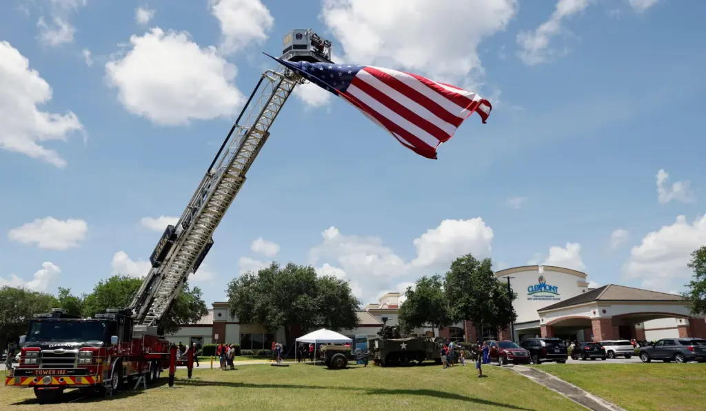 Clermont Fire Department Tower 103 displays the US Flag during...