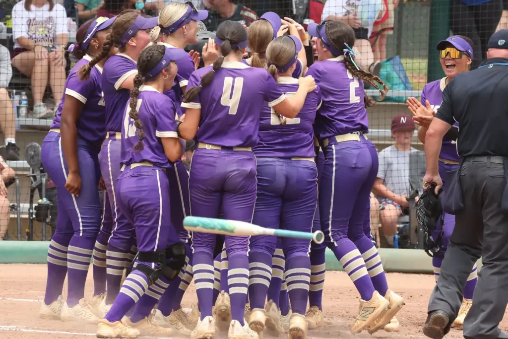 Winter Springs players converge on teammate Abigail Hooper (16) after...