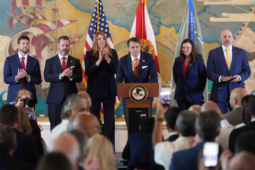 Acting Attorney General Todd Blanche, center, speaks at an event