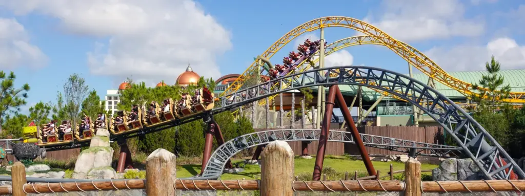 Guests ride the Hiccup's Wing Gliders roller coaster, in the...