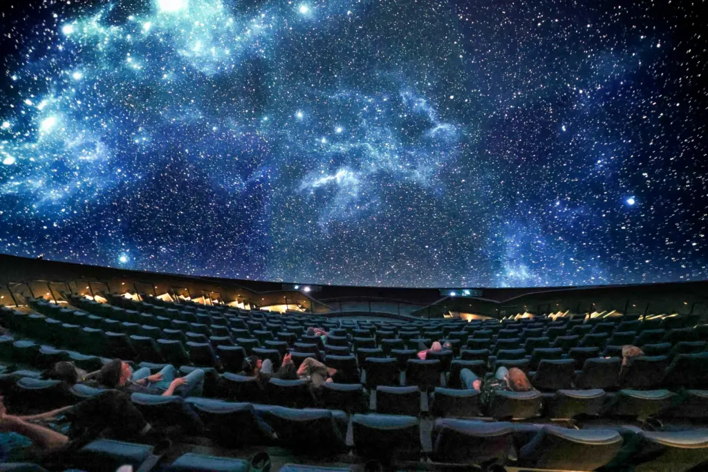 A scene is projected on the massive screen of the...