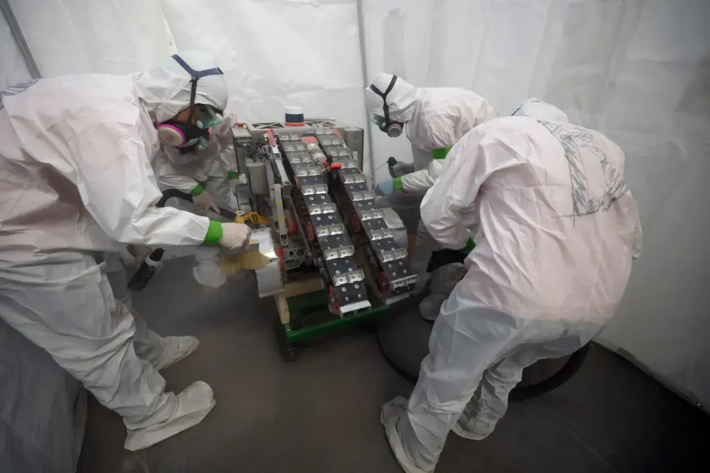 University of Alabama team members clean their robot after competing...