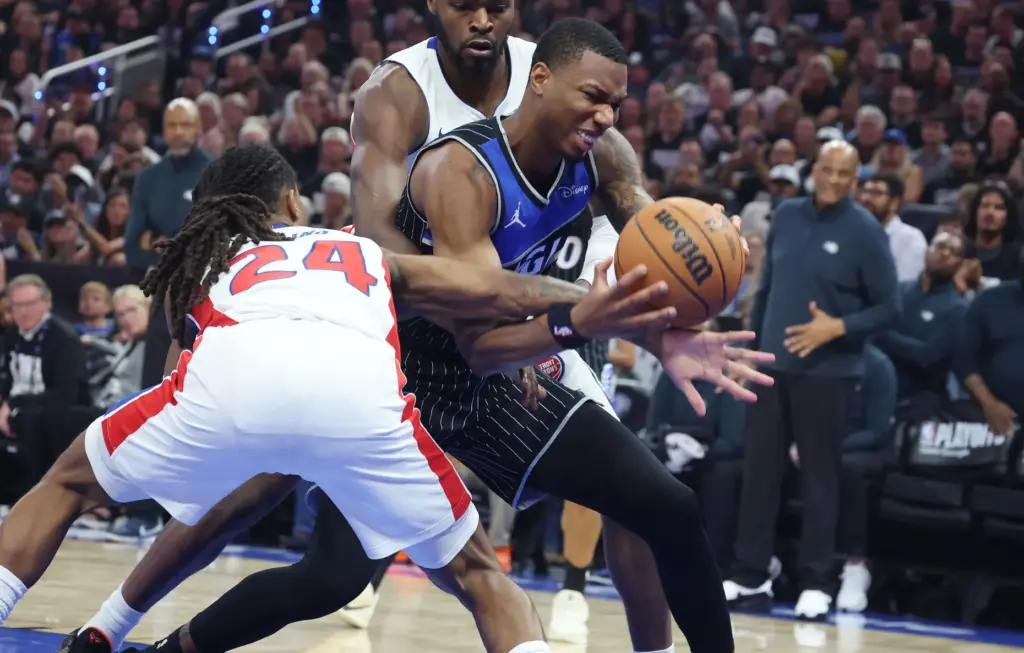 Orlando forward Jamal Cain (right) can't get past Detroit guard...