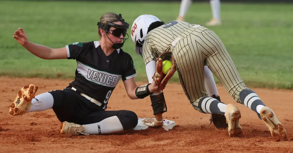 East Ridge High softball player Veronica Peterson (3) holds on...