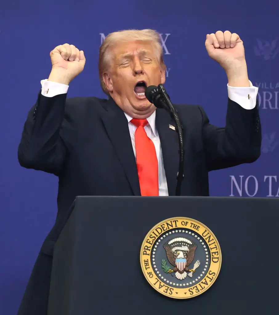 President Donald Trump mimics weightlifting while criticizing transgender athletes participating...