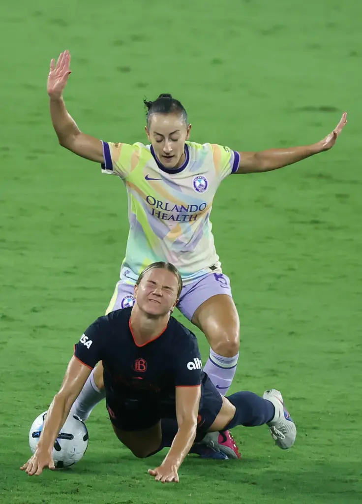 Orlando player Luana (top) runs over Bay FC player Claire...