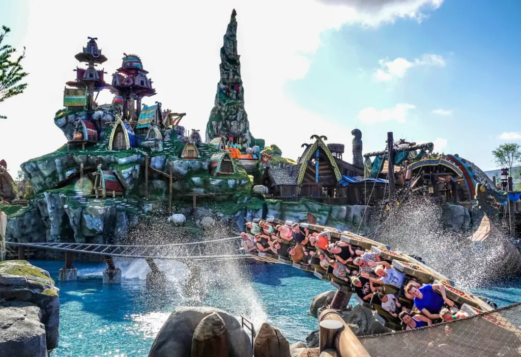 Guests ride the Hiccup's Wing Gliders roller coaster in the...
