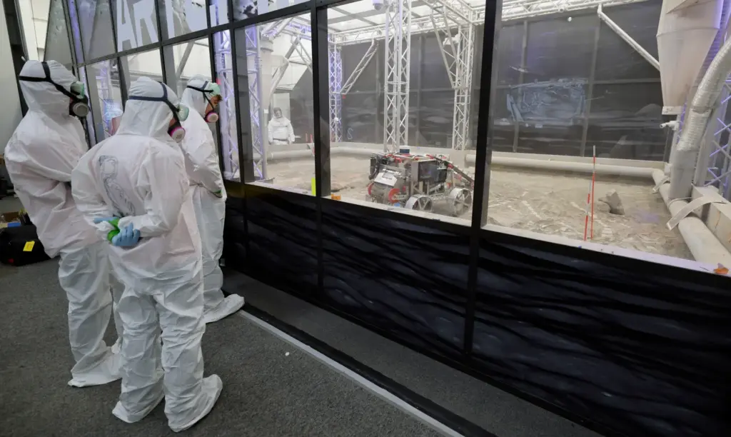 University of Alabama team members watch their robot make a...