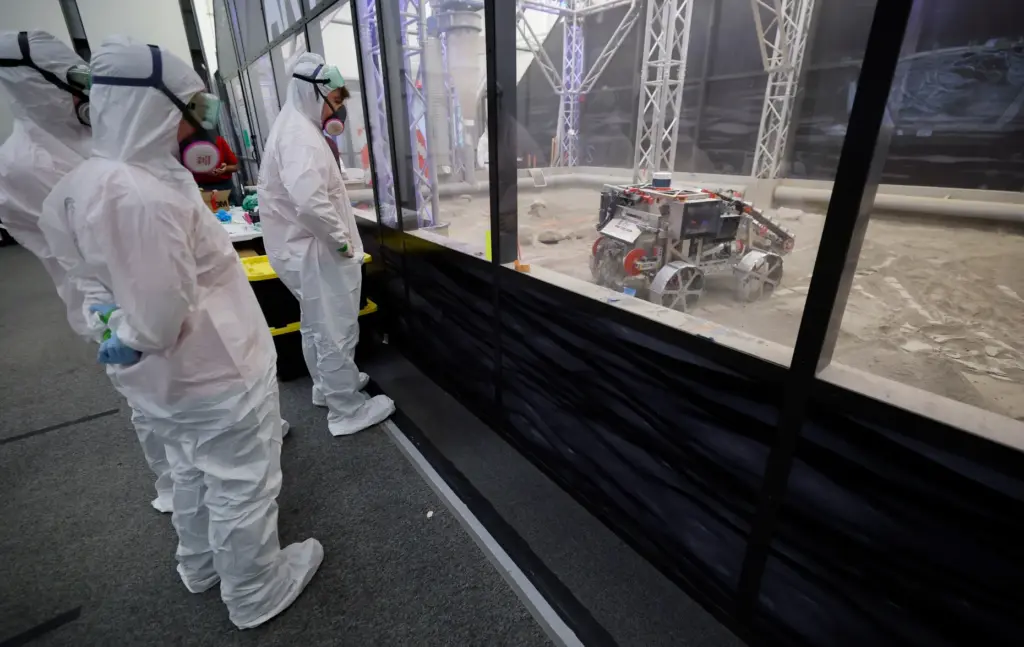 University of Alabama team members watch their robot make a...