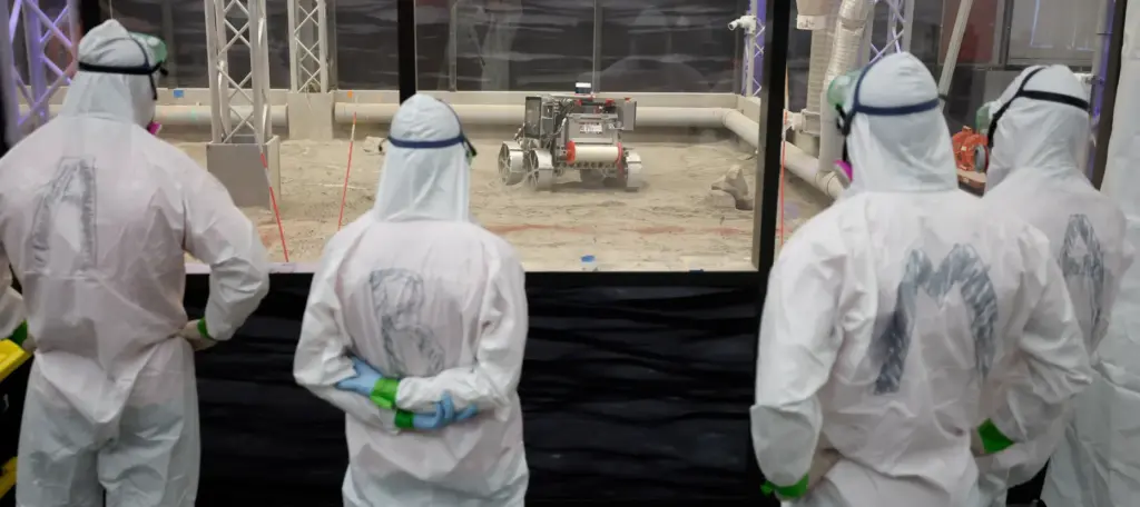 The University of Alabama team members watch their robot make...
