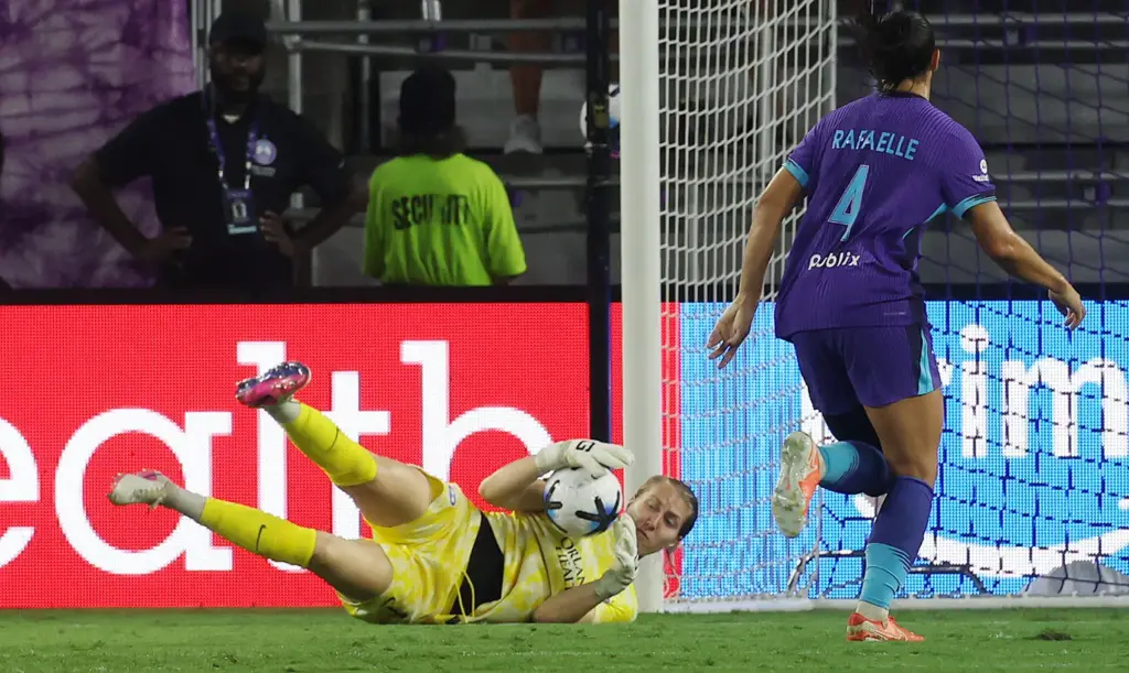 Orlando goalkeeper Anna Moorhouse (bottom) makes a stop beside Orlando...