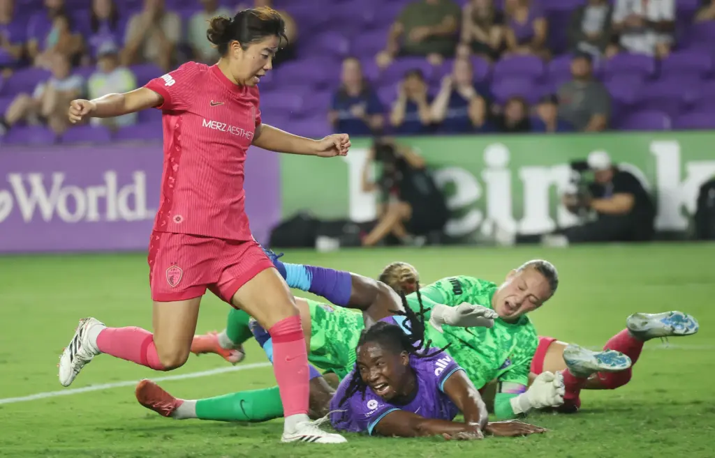 Orlando player Barbra Banda (middle) collides with North Carolina goalkeeper...