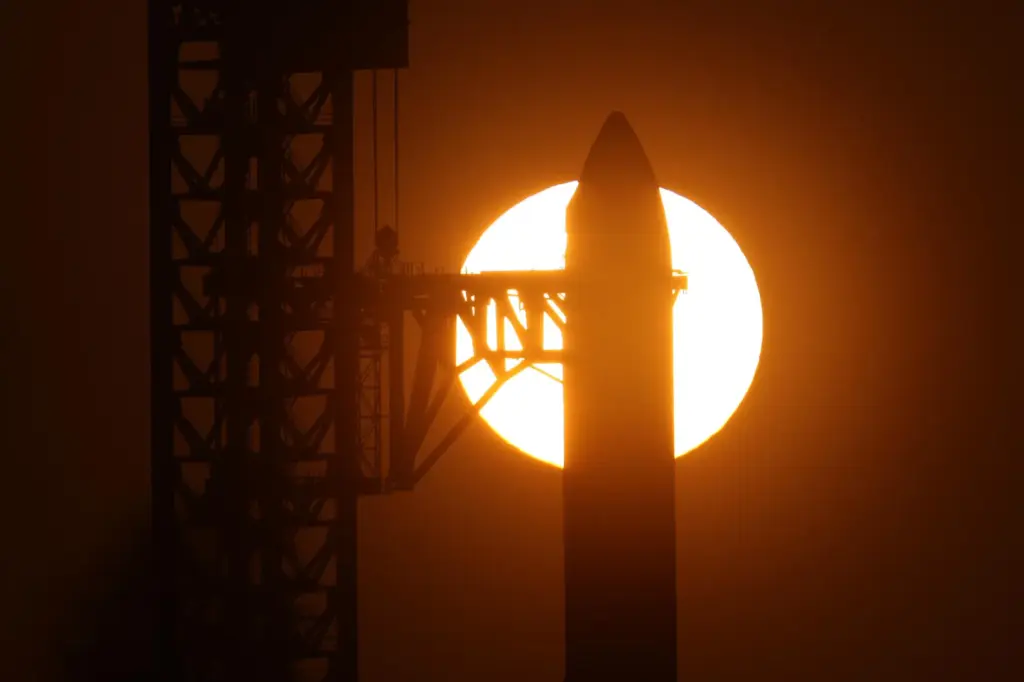 The sun rises behind SpaceX’s mega rocket Starship as it...