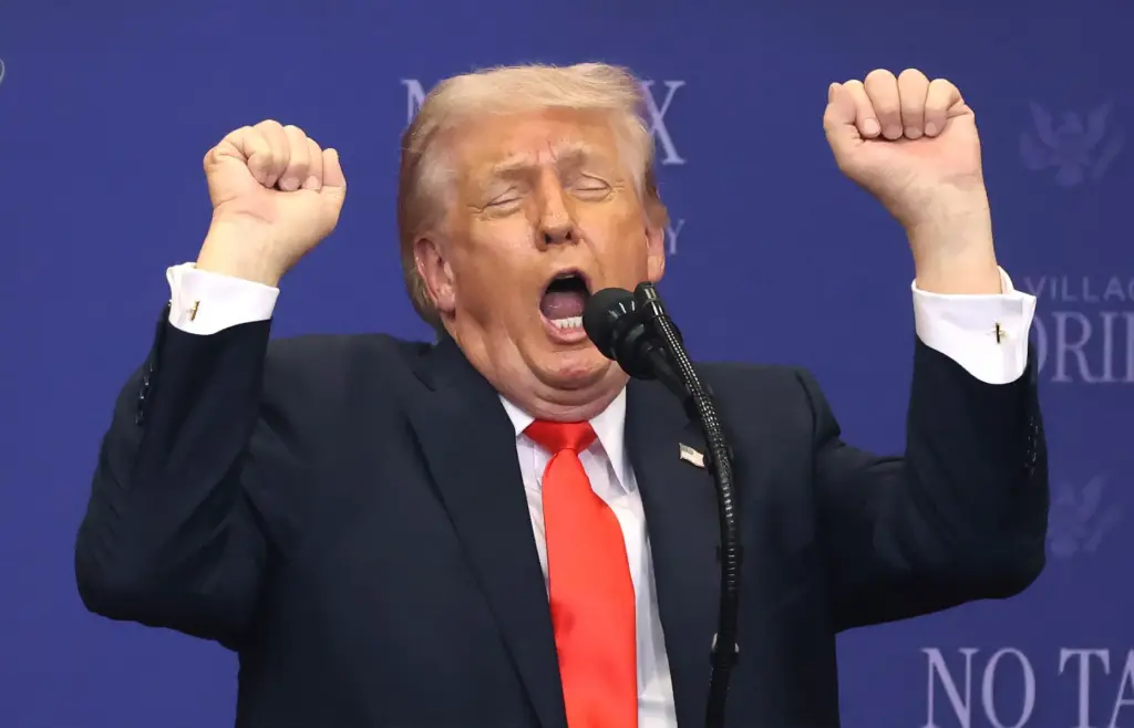 President Donald Trump mimics weightlifting while criticizing transgender athletes participating...