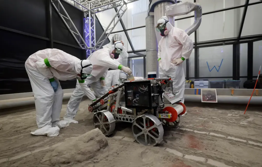 University of Alabama team members clean their robot after competing...