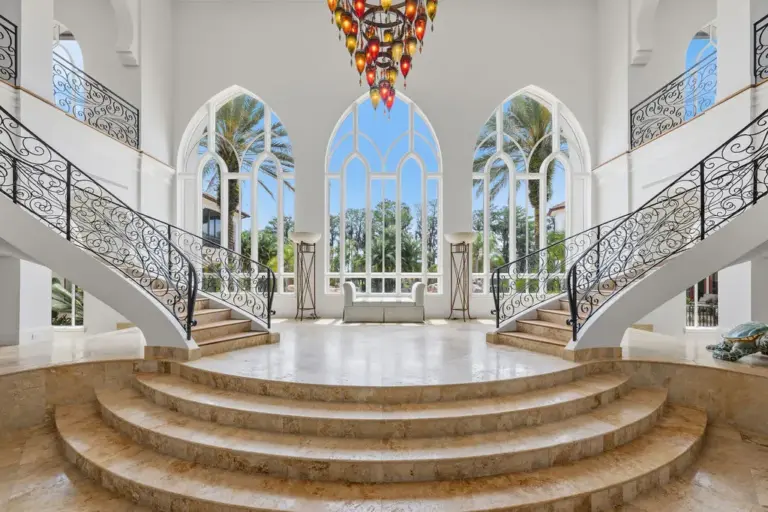 Inside, a 28-foot grand foyer unfolds beneath soaring ceilings, anchored...