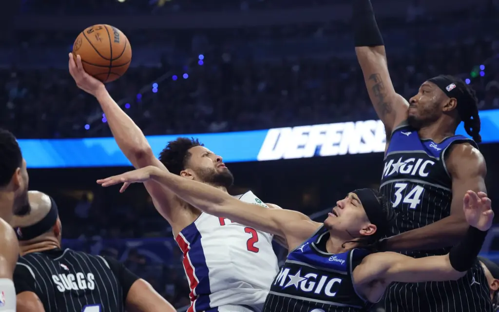 Pistons guard Cade Cunningham (2) shoots past Magic guard Anthony Black (bottom) and Orlando center Wendell Carter Jr. (34) during Friday's Game 6 inside Kia Center. (Stephen M. Dowell/Orlando Sentinel)