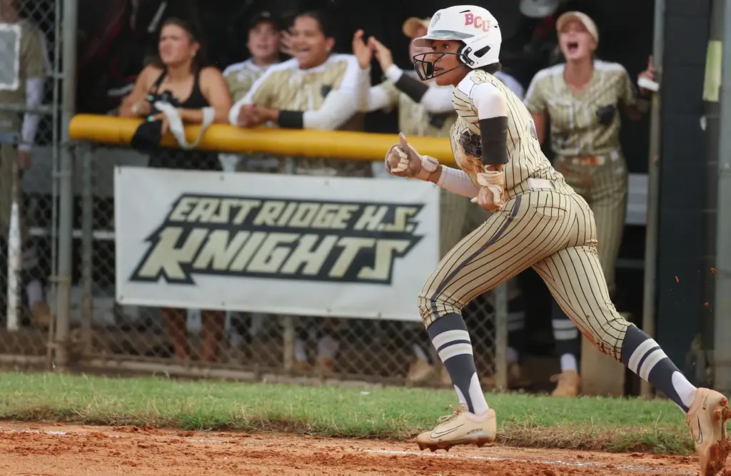 East Ridge High softball player Victoria Peterson runs after a...