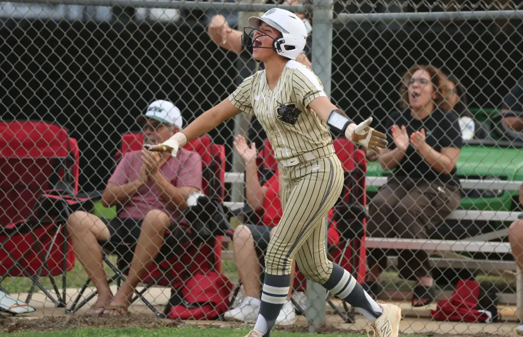 East Ridge High softball player Bailey Page screams in celebration...