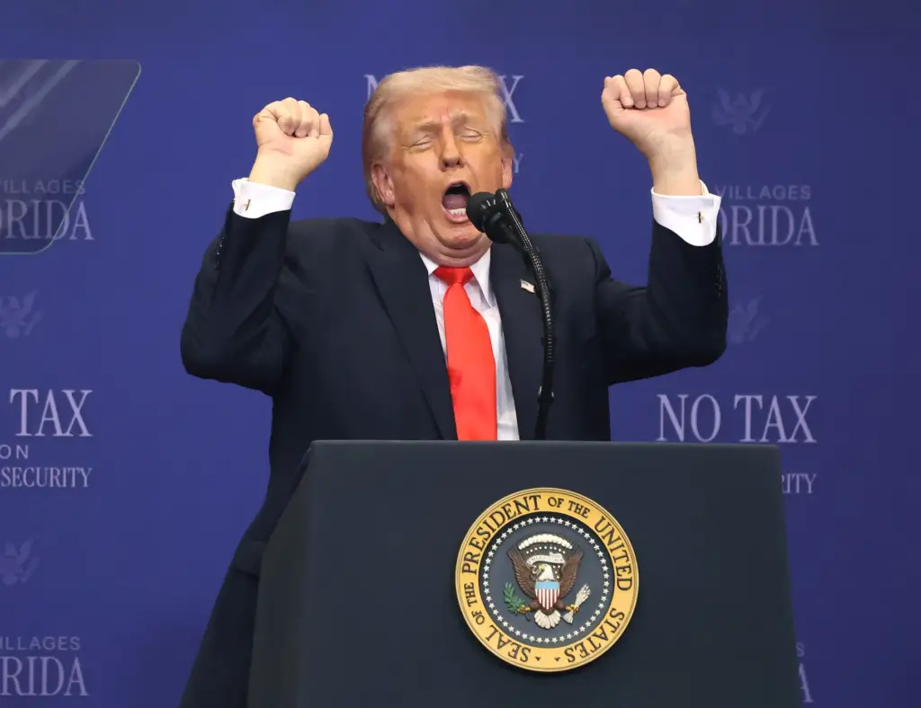 President Donald Trump mimics weightlifting while criticizing transgender athletes participating...