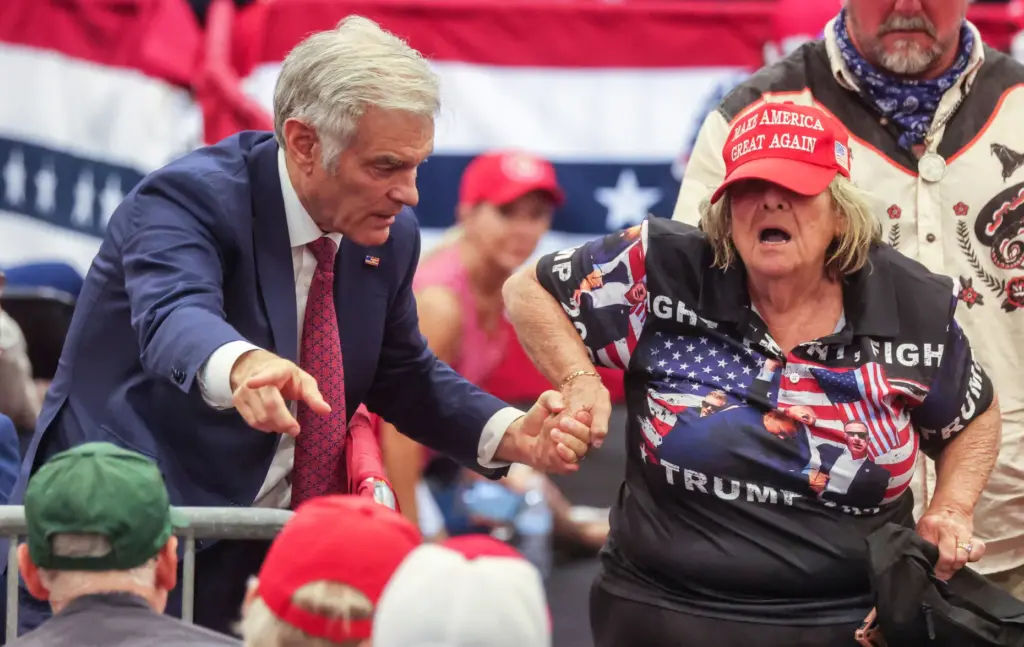 U.S. Medicare administrator Dr. Mehmet Oz assists an elderly supporter...