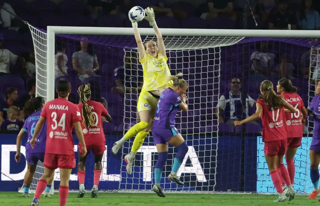 Orlando goalkeeper Anna Moorhouse (top) makes a save during the...