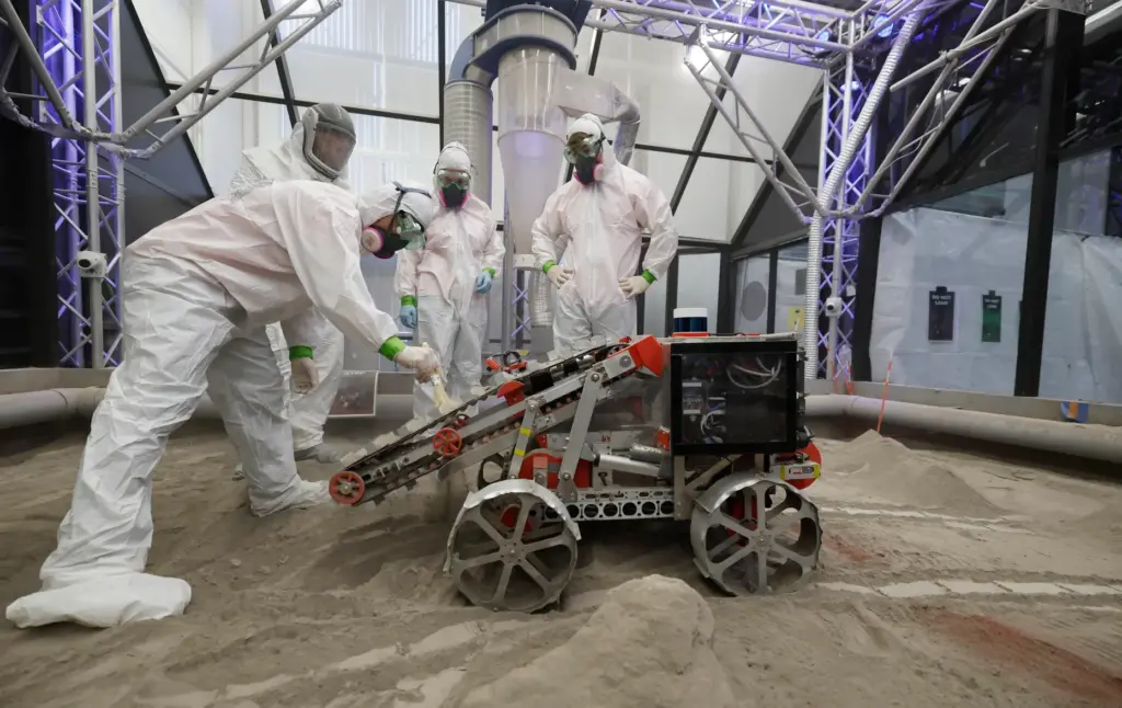 University of Alabama team members clean their robot after competing...