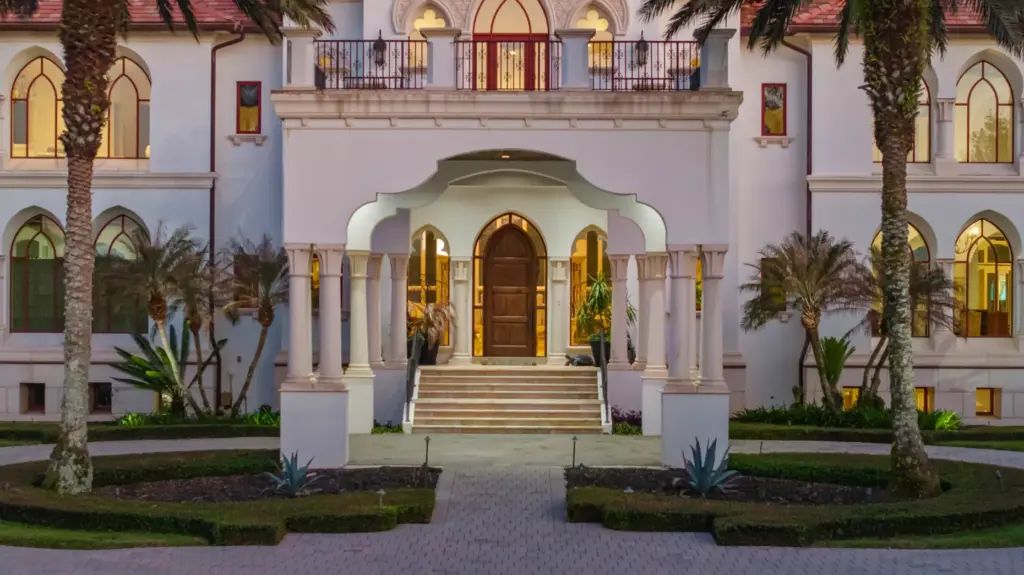 The grand entrance of the estate features a porte cochere...