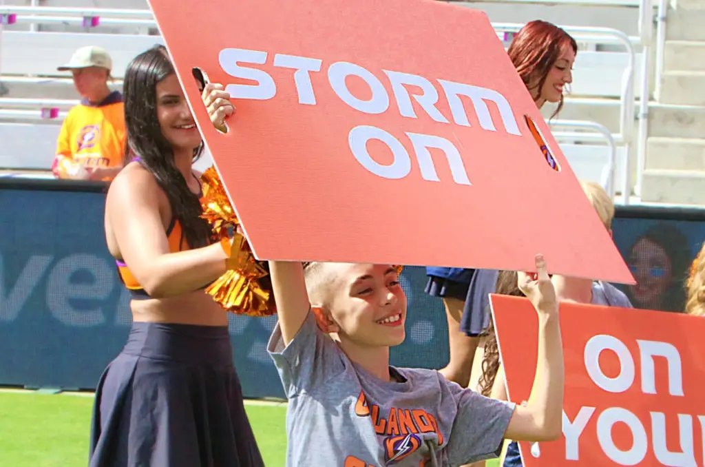 A young member of the Orlando Storm Surge cheerleaders flashes...