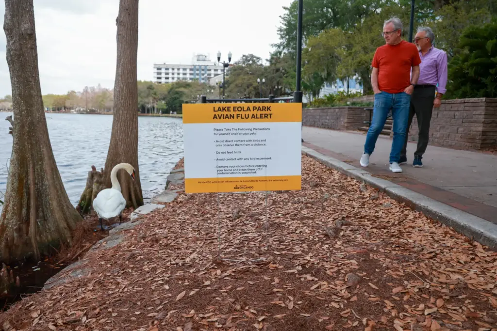 A sign posted at Lake Eola Park warns about Avian...