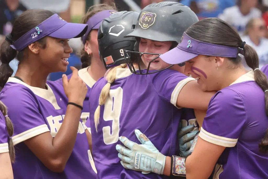 Winter Springs players converge on teammate Abigail Hooper (middle) after...