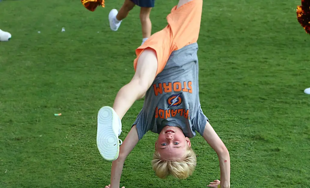 A young Orlando Storm Surge yell leader does a back...