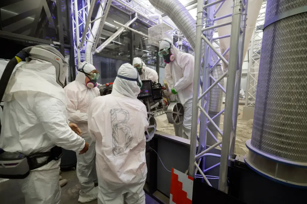 University of Alabama team members take their robot out of...