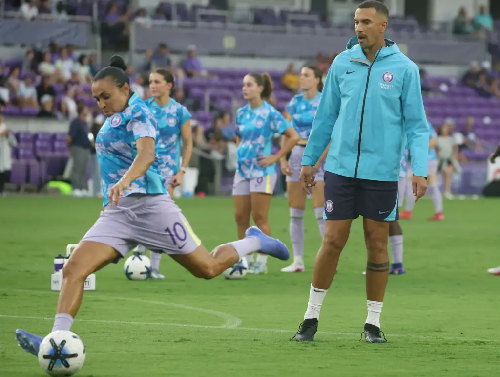 Orlando coach Seb Hines watches Orlando player Marta warm up...