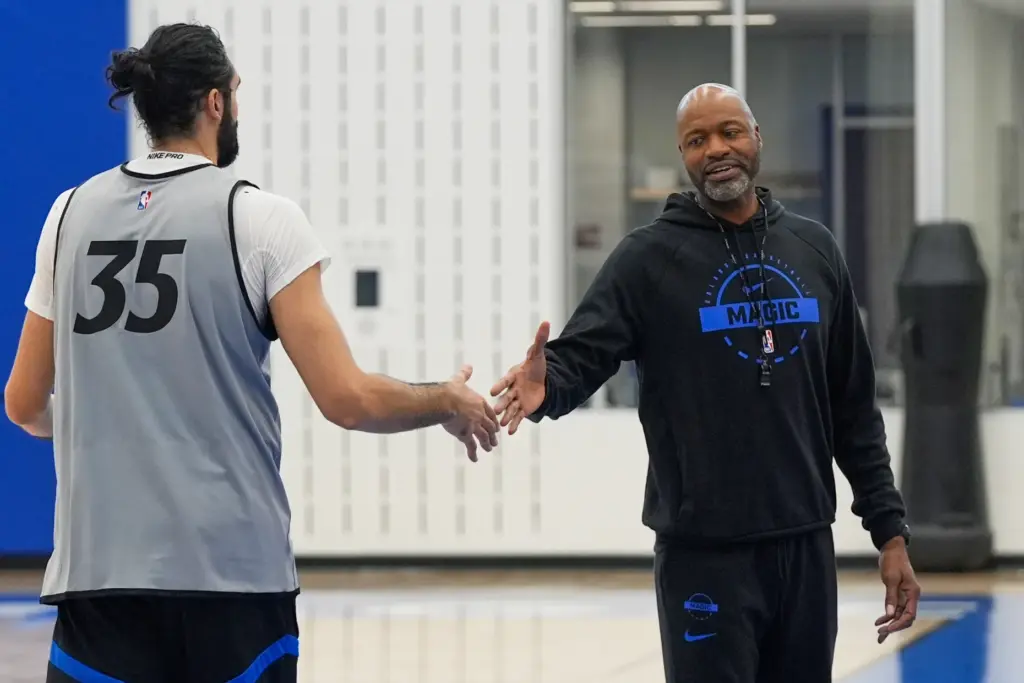 Orlando Magic head coach Jamahl Mosley, right, shakes hand with...
