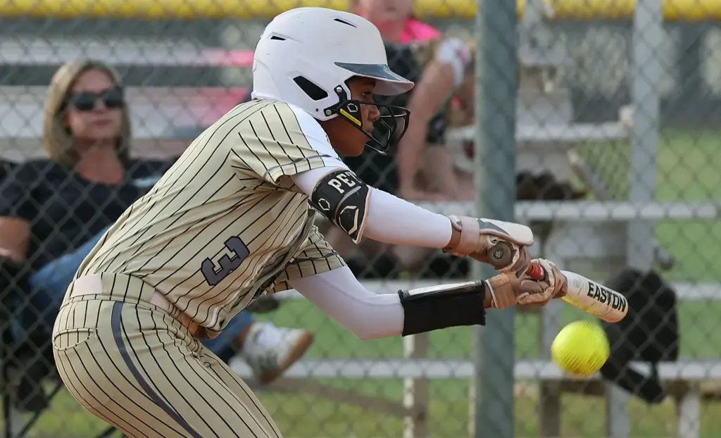 East Ridge High softball player Veronica Peterson bunts during the...