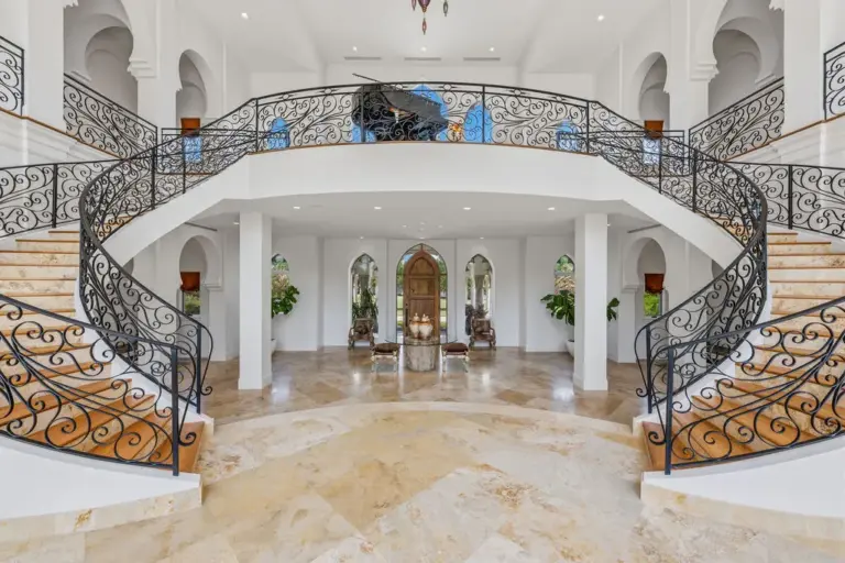Inside, a 28-foot grand foyer unfolds beneath soaring ceilings, anchored...