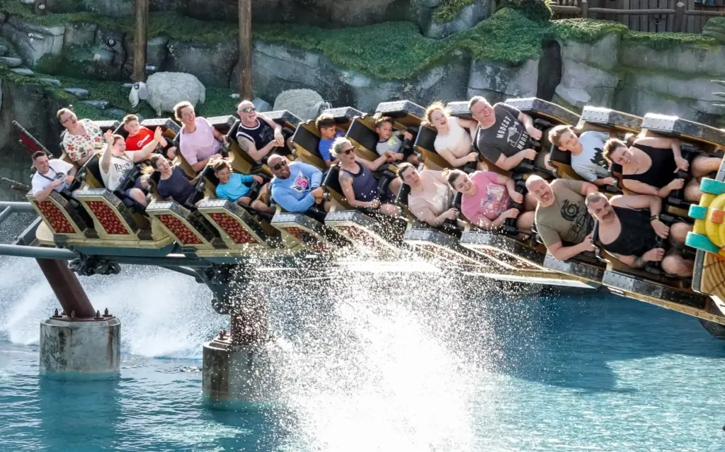 Guests ride the Hiccup's Wing Gliders roller coaster, in the...