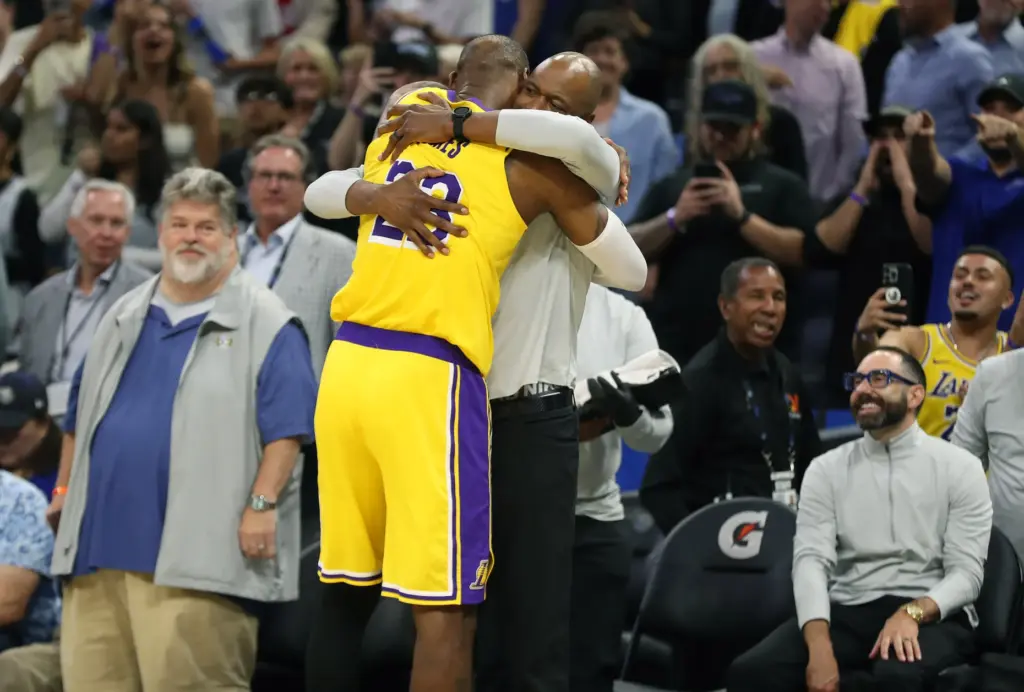 Los Angeles Lakers forward LeBron James (23) hugs Orlando Magic...