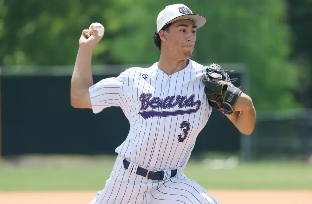 Winter Springs High baseball pitcher Robbie Mungovan throws during the...
