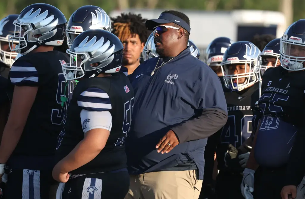 Lake Howell coach Dazzie Morris coaches players during a Spring...