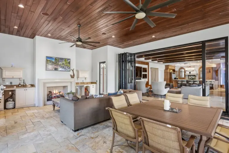 The lanai features a wood-burning fireplace and summer kitchen. (Photo...