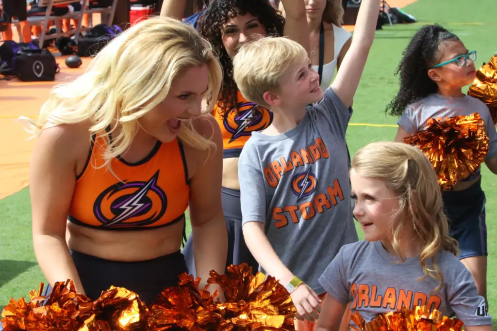 A member of the Orlando Surge dance helps the youngsters...