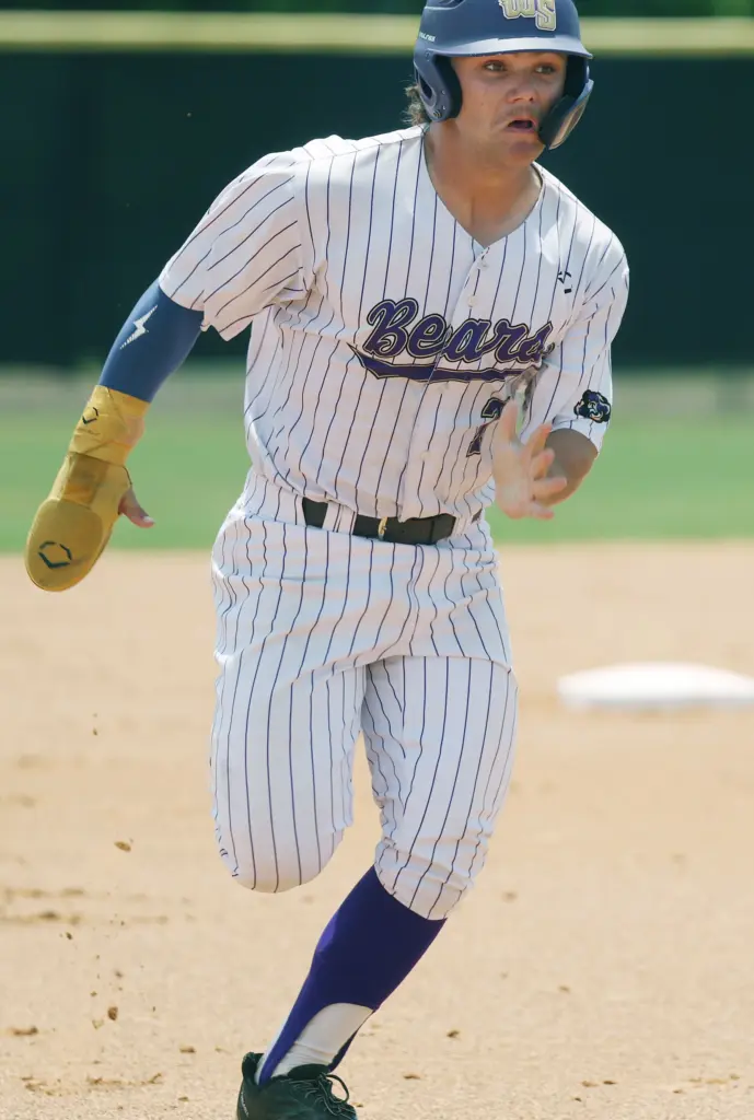 Winter Springs High baseball player Jackson Swann runs to third...