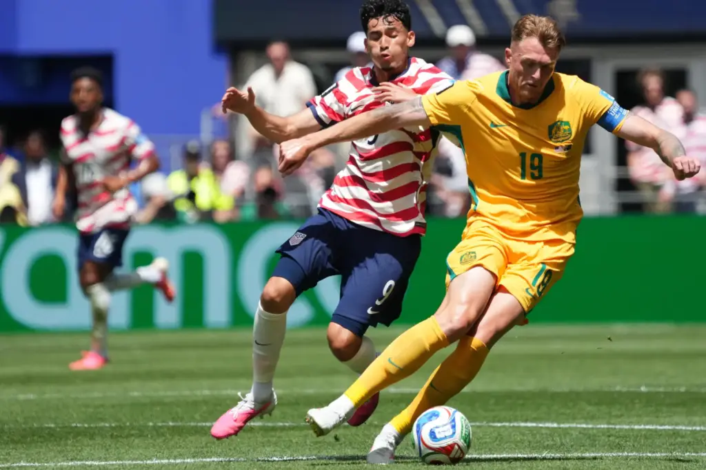 United States’ Ricardo Pepi (9) and Australia’s Harry Souttar (19)...