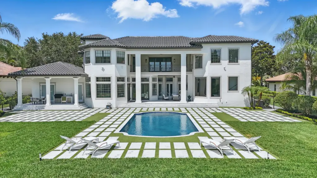 The spacious backyard has a pool and summer kitchen, and...