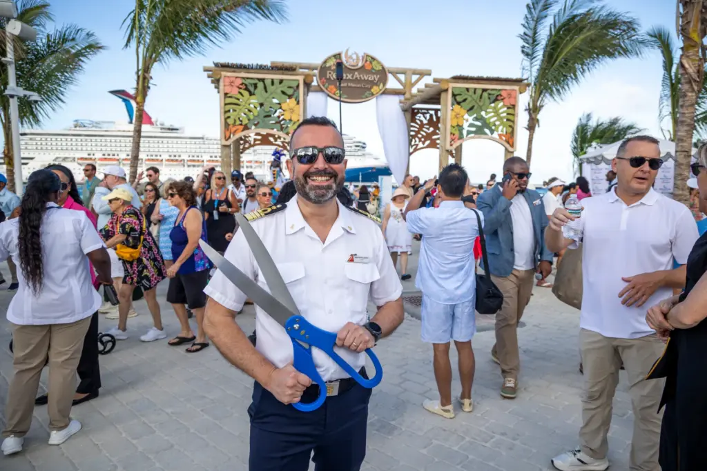 Carnival Sunrise Capt. Martino Pellegrini holds the oversized pair of...