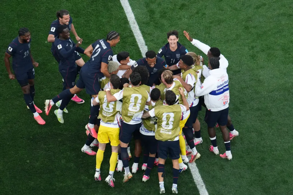 United States’ Auston Trusty celebrates with teammates after scoring his...