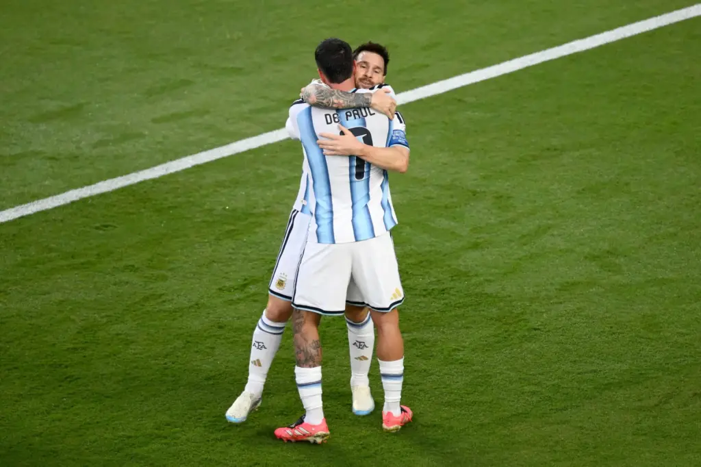 Argentina’s Lionel Messi (10) celebrates with Rodrigo de Paul (7)...