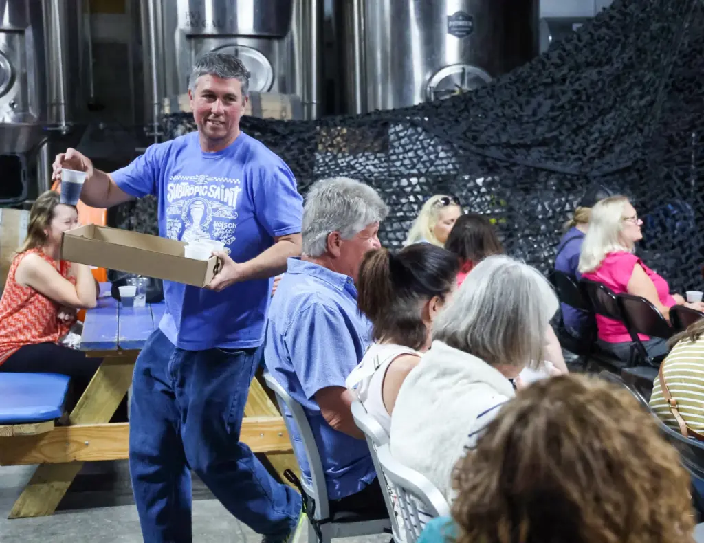 Ten10 Brewing owner Mike Wallace hands out samples of âSentinel...